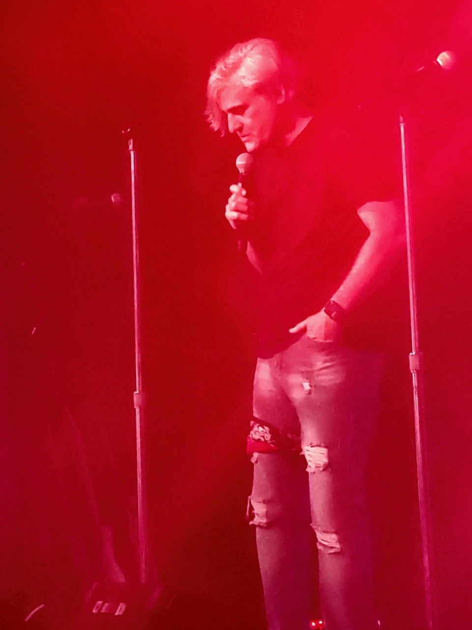 A Walkmans vocalist holding the microphone in a quiet moment on stage